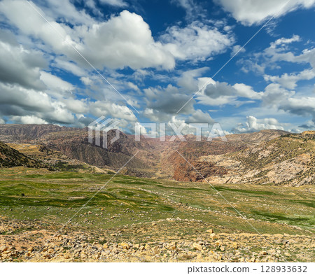 Typical mountain landscape, Jordan, Middle East (photography from a high point). Against the background of a beautiful sky with clouds Typical mountain landscape, Jordan, Middle East (photography from a high point). Against the background of a beautiful sky with clouds 128933632
