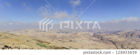 Typical mountain landscape (panoramic view), Jordan, Middle East (photography from a high point). Against the background of a beautiful sky with clouds Typical mountain landscape (panoramic view), Jordan, Middle East (photography from a high point). Against the background of a beautiful sky with clouds 128933639