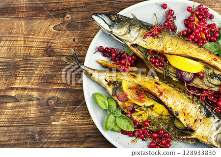 Oven baked mackerel on wooden surface. Oven baked mackerel on wooden surface. 128933830