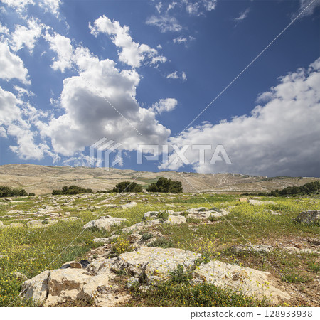 Typical mountain landscape, Jordan, Middle East (photography from a high point). Against the background of a beautiful sky with clouds Typical mountain landscape, Jordan, Middle East (photography from a high point). Against the background of a beautiful sky with clouds 128933938