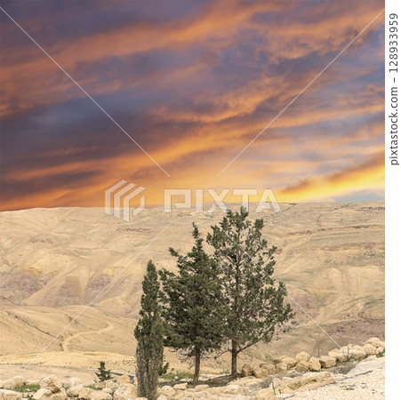 Typical mountain landscape, Jordan, Middle East (photography from a high point). Against the background of a beautiful sky with clouds Typical mountain landscape, Jordan, Middle East (photography from a high point). Against the background of a beautiful sky with clouds 128933959