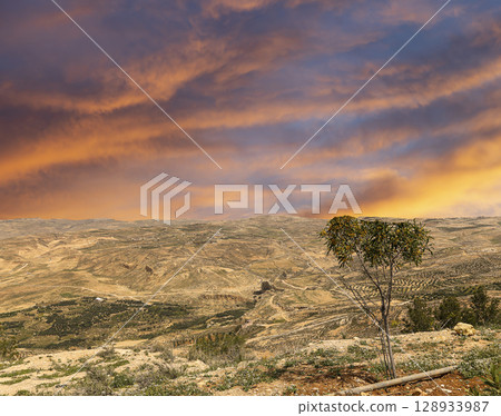 Typical mountain landscape, Jordan, Middle East (photography from a high point). Against the background of a beautiful sky with clouds Typical mountain landscape, Jordan, Middle East (photography from a high point). Against the background of a beautiful sky with clouds 128933987