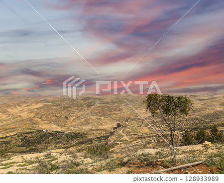 Typical mountain landscape, Jordan, Middle East (photography from a high point). Against the background of a beautiful sky with clouds Typical mountain landscape, Jordan, Middle East (photography from a high point). Against the background of a beautiful sky with clouds 128933989