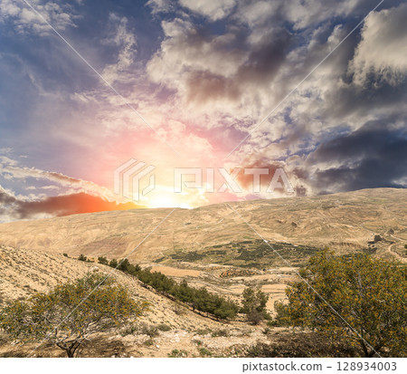 Typical mountain landscape, Jordan, Middle East (photography from a high point). Against the background of a beautiful sky with clouds Typical mountain landscape, Jordan, Middle East (photography from a high point). Against the background of a beautiful sky with clouds 128934003
