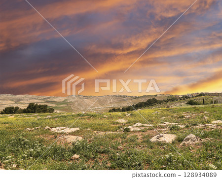 Typical mountain landscape, Jordan, Middle East (photography from a high point). Against the background of a beautiful sky with clouds Typical mountain landscape, Jordan, Middle East (photography from a high point). Against the background of a beautiful sky with clouds 128934089