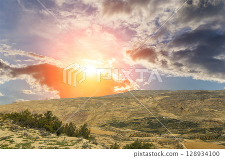 Typical mountain landscape, Jordan, Middle East (photography from a high point). Against the background of a beautiful sky with clouds Typical mountain landscape, Jordan, Middle East (photography from a high point). Against the background of a beautiful sky with clouds 128934100