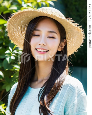A woman wearing a straw hat A woman wearing a straw hat 128934263