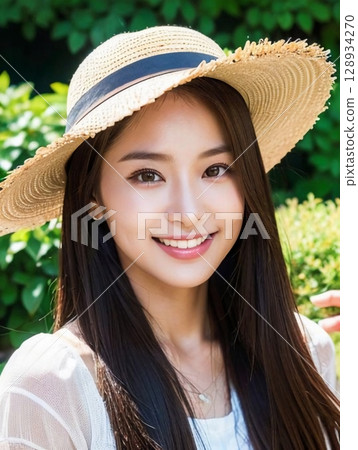 young woman wearing a straw hat 128934270