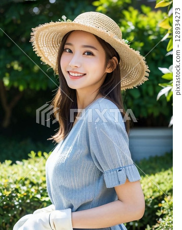 A woman wearing a straw hat A woman wearing a straw hat 128934273