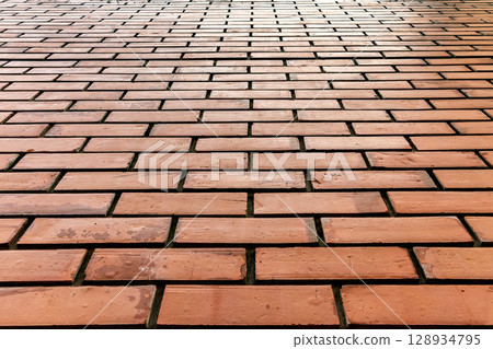 Red brick wall pattern with straight horizontal alignment viewed from a low perspective 128934795