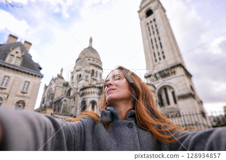 Happy woman taking selfie near Sacre Coeur in Montmartre Paris Happy woman taking selfie near Sacre Coeur in Montmartre Paris 128934857