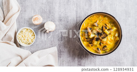 Cheese mushroom soup with herbs in a bowl on the table top view web banner Cheese mushroom soup with herbs in a bowl on the table top view web banner 128934931