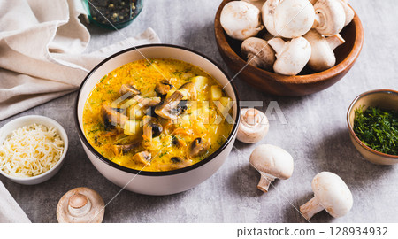 Delicious soup with vegetables, mushrooms and cheese in a bowl on the table web banner Delicious soup with vegetables, mushrooms and cheese in a bowl on the table web banner 128934932