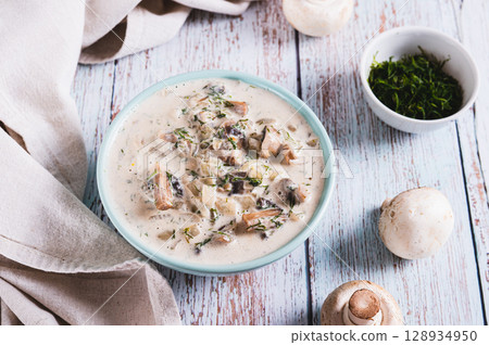Cheesy stewed mushroom sauce in a bowl on the table 128934950