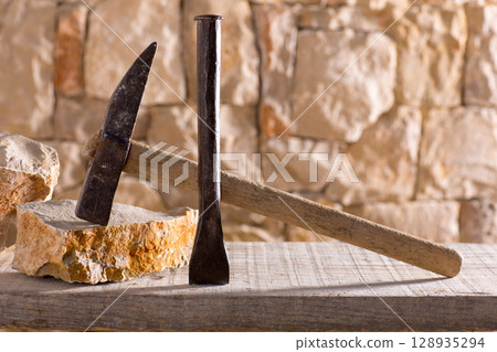 Hammer tools of stonecutter masonry work 128935294