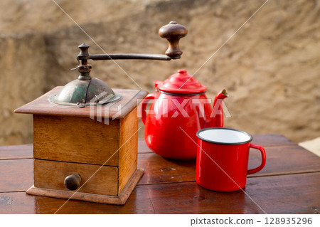 retro old coffee grinder with vintage red teapot 128935296