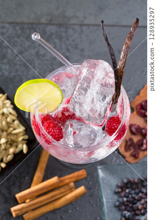Gin tonic cocktail with vanilla raspberry lima slice and ice 128935297