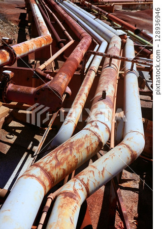 Aged rusty grunge industrial pipe lines 128936946