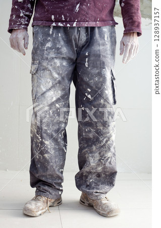 hands dirty trousers of plastering painter man 128937157