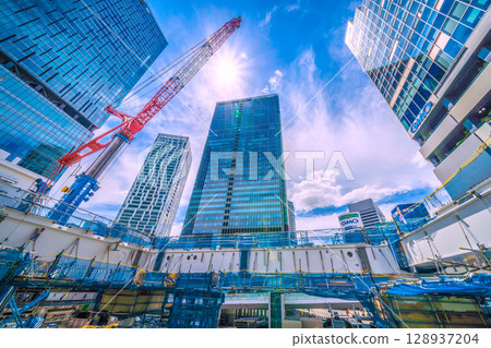 Tokyo cityscape, Japan. July 27th. Extremely hot... Steel beams assembled next to the Fukuras deck... Full-scale construction begins. Tokyo cityscape, Japan. July 27th. Extremely hot... Steel beams assembled next to the Fukuras deck... Full-scale construction begins. 128937204