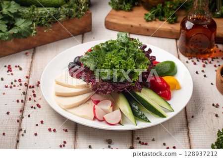 Fresh vegetable and cheese platter with herbs 128937212