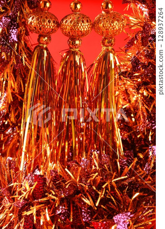 Golden christmas macro decoration, red background Golden christmas macro decoration, red background 128937264
