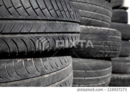 car tires pneus stacked in rows 128937273
