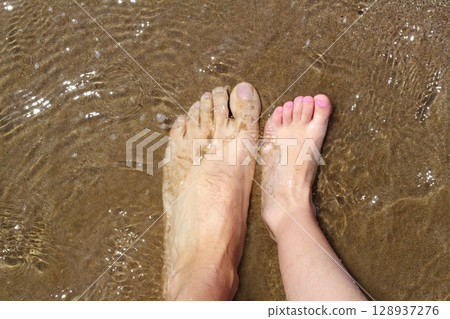 father and children feet on summer sand beach father and children feet on summer sand beach 128937276