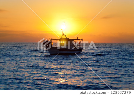 fishing boat in sunrise at Mediterranean sea 128937279