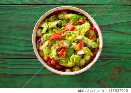 Guacamole with avocado and tomatoes mexican 128937440