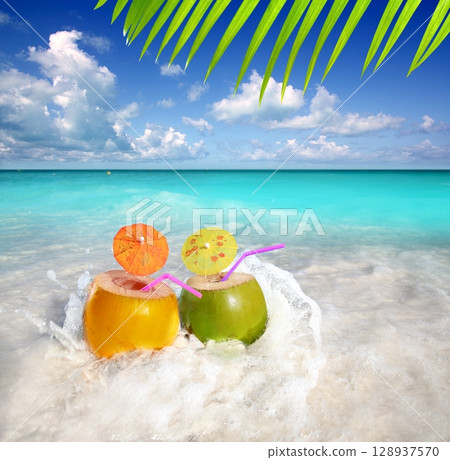 coconut cocktails juice in tropical beach water splash coconut cocktails juice in tropical beach water splash 128937570