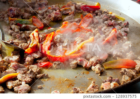 Paella from Spain first steps cooking big pan 128937575