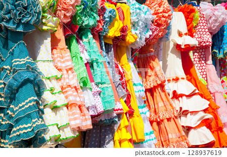 colorful gipsy dresses in rack hanged in Spain 128937619