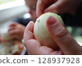 two child's hands cutting vegetables for salad close up 128937928