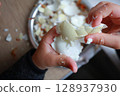two child's hands cutting vegetables for salad close up 128937930