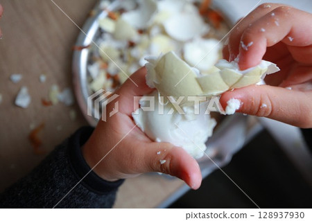 two child's hands cutting vegetables for salad close up two child's hands cutting vegetables for salad close up 128937930