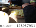 two child's hands cutting vegetables for salad close up 128937931