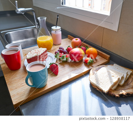 Breakfast in kitchen with coffee bread fruit juice Breakfast in kitchen with coffee bread fruit juice 128938117