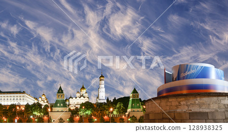 Moscow Kremlin (with decorations for the holiday of May 9 in honor of Victory Day celebration (WWII). Against the sky with clouds, Russia. TRANSLATION: Victory! 128938325