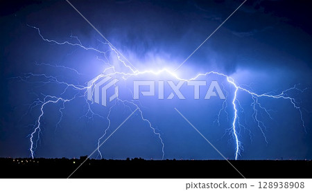 A natural phenomenon of massive lightning and thunder that lights up the night sky 128938908