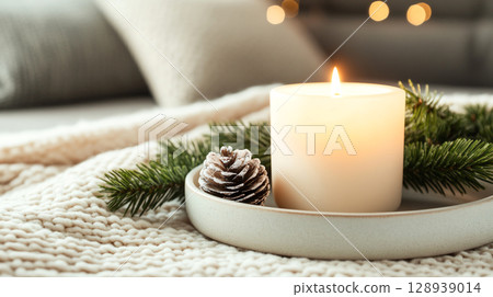 cozy candle lit table adorned with Christmas decorations featuring soft textures and shimmering ornaments creating warm holiday festive seasonal Christmas New Year celebration vibe atmosphere 128939014