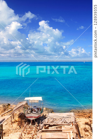 Formentera Es Ram beach with traditional boat Formentera Es Ram beach with traditional boat 128939355