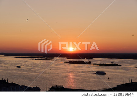 Golden Sunset Over Volga River with Cruising Ship 128939644