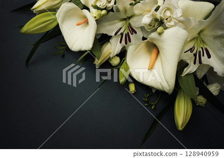 White delicate calla lily flowers composition, condolence flower background card, funeral concept image, selective focus, shallow DOF 128940959