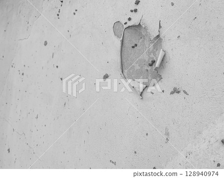 The Walls and backgrounds Old cement walls with black stains on the surface caused by moisture. Peeling wall surface with cracks and scratches, old rough gray cement wall surface for the background. 128940974