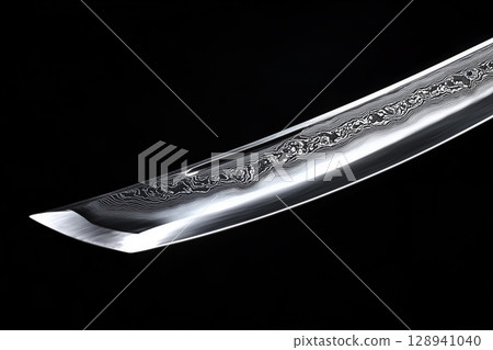 The tip of a Japanese sword on a black background The tip of a Japanese sword on a black background 128941040