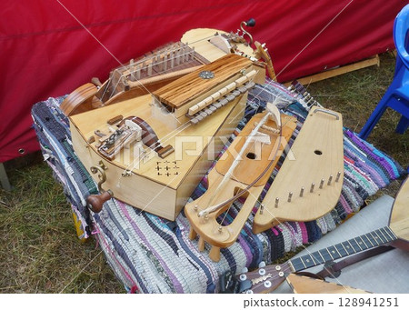 Traditional vintage stringed musical instruments on a colorful mat Traditional vintage stringed musical instruments on a colorful mat 128941251