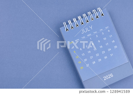 July 2026 calendar on blue color background. Desk calendar for planning and organizing. 128941589