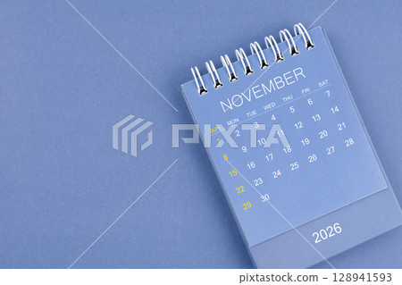 November 2026 calendar on blue color background. Desk calendar for planning and organizing. 128941593