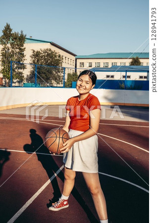 female youth smiling before basketball match, team spirit, friendship and fitness female youth smiling before basketball match, team spirit, friendship and fitness 128941793